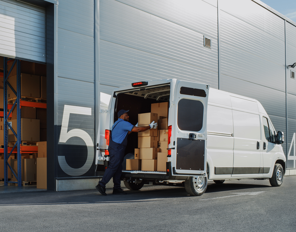 person loads boxes into or out of a white van